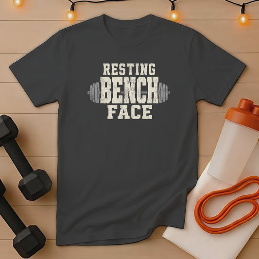 Dark gray t-shirt with "Resting Bench Face" text and barbell graphic.