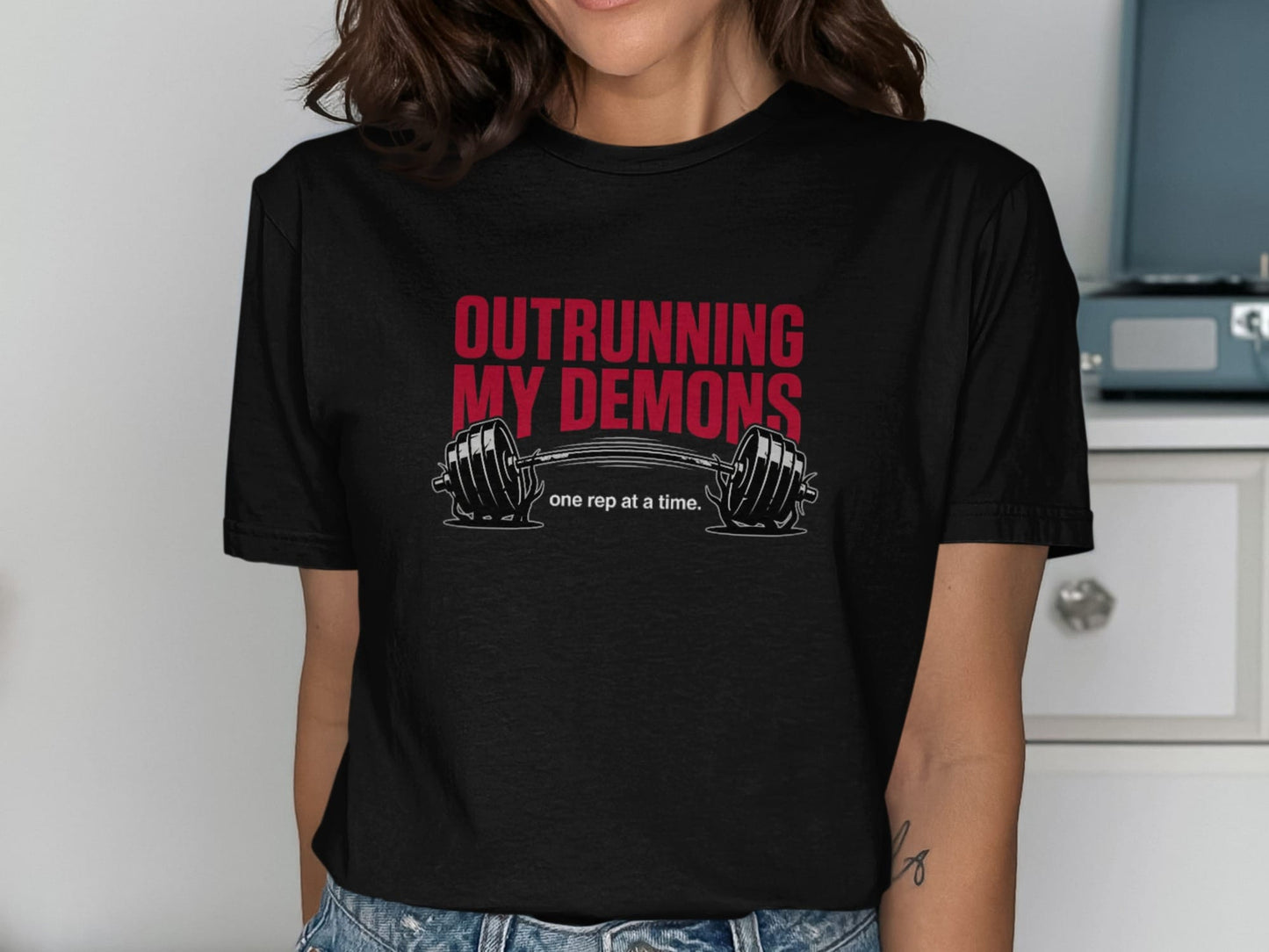 Black t-shirt with "OUTRURNING MY DEMONS" and a barbell.