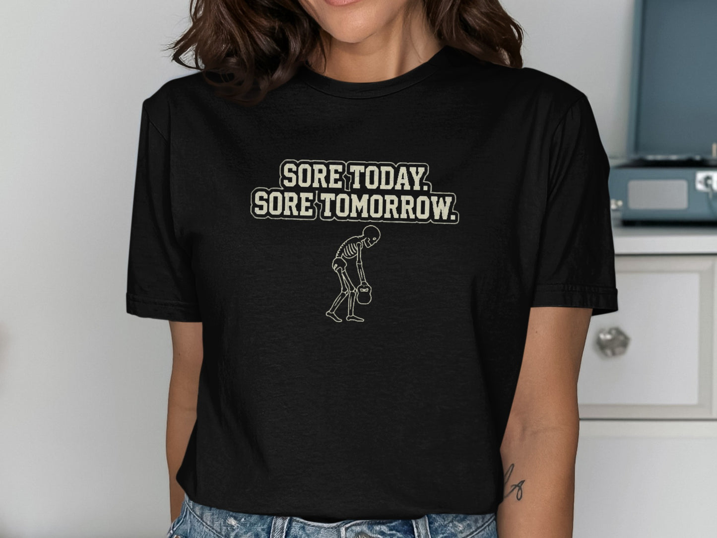 Black t-shirt with "SORE TODAY, SORE TOMORROW" and skeleton graphic.