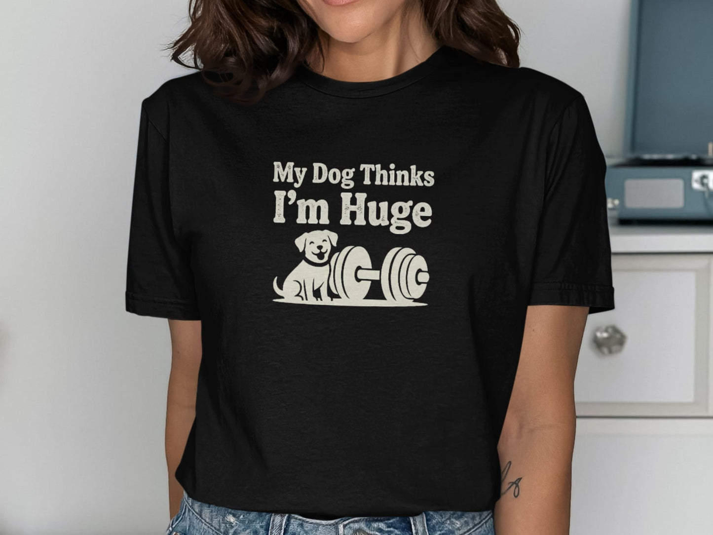 Black t-shirt with "My Dog Thinks I'm Huge" and a cartoon dog next to a dumbbell.