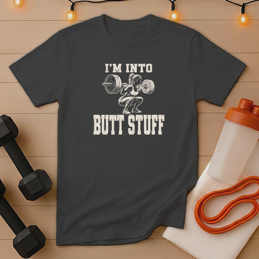 Dark t-shirt with "I'M INTO BUTT STUFF" printed over a squatting weightlifter graphic.