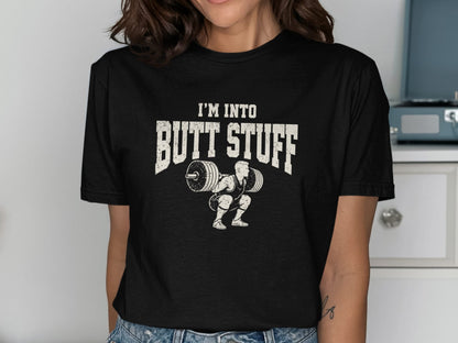 Black t-shirt with distressed graphic of weightlifter squatting and text "I'M INTO BUTT STUFF."