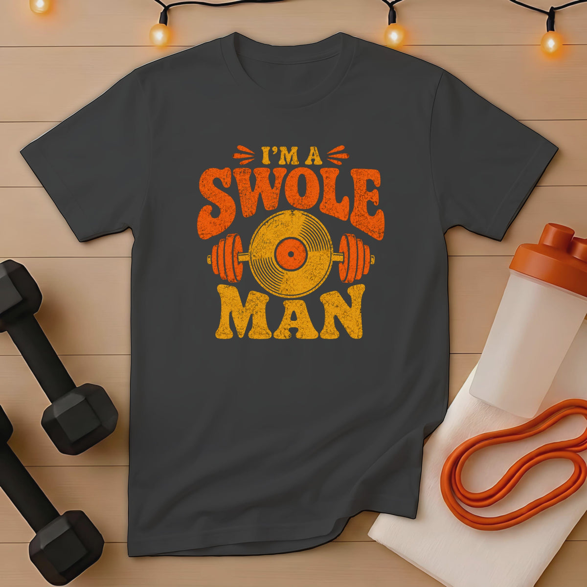 Dark grey t-shirt with distressed orange and yellow "I'm a Swole Man" text and vinyl record graphic.