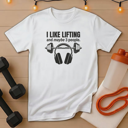 White t-shirt with "I like lifting and maybe 3 people" and headphones graphic.