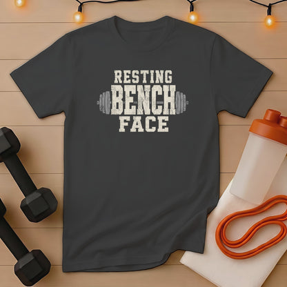 Dark gray t-shirt with "Resting Bench Face" text and barbell graphic.