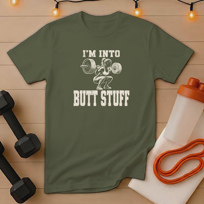 Olive green t-shirt with graphic "I'M INTO BUTT STUFF" and barbell squatting woman.