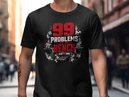 Black t-shirt with graphic: "99 PROBLEMS BUT MY BENCH AIN'T ONE" and weightlifting equipment.