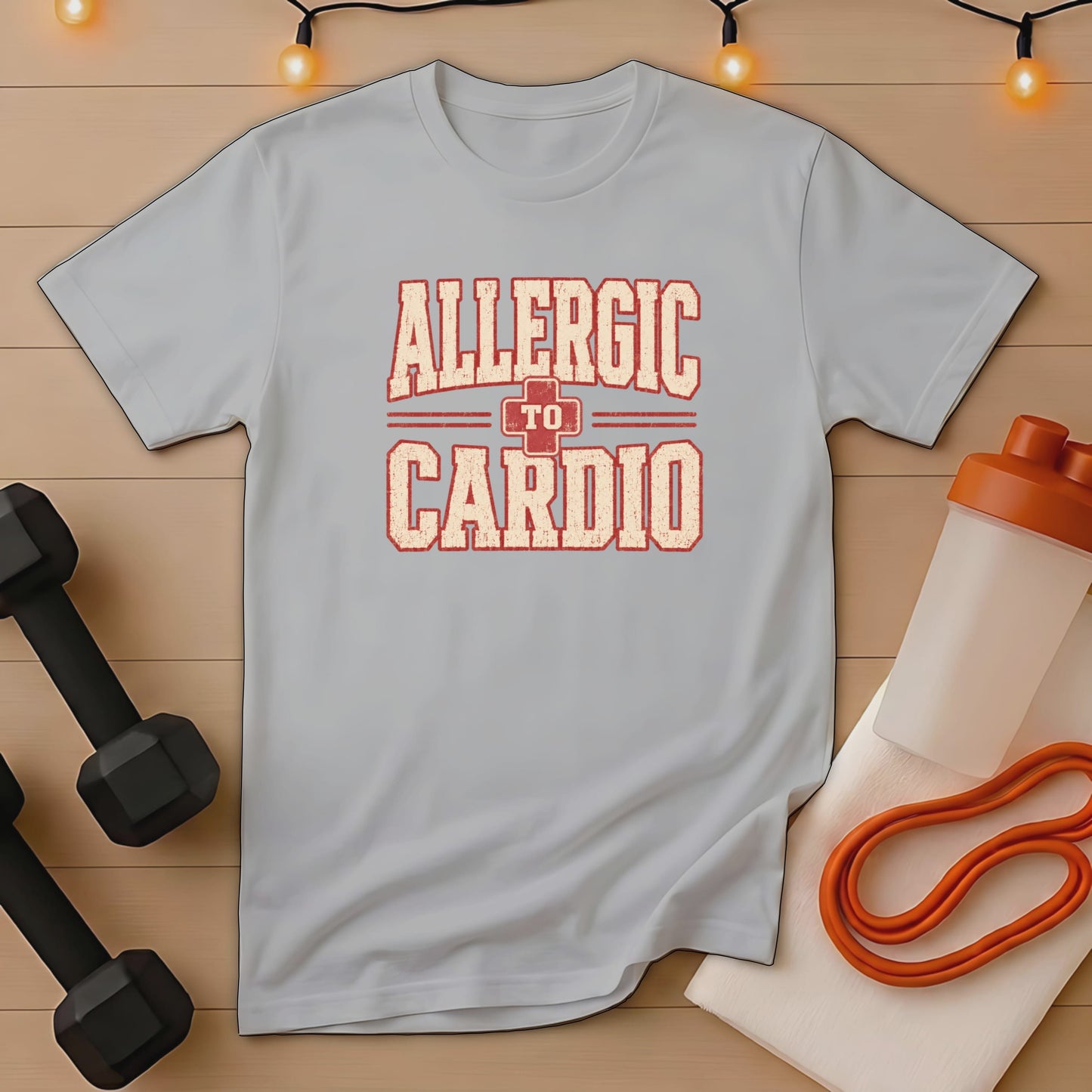 Light gray t-shirt with distressed text "ALLERGIC TO CARDIO" and workout accessories.