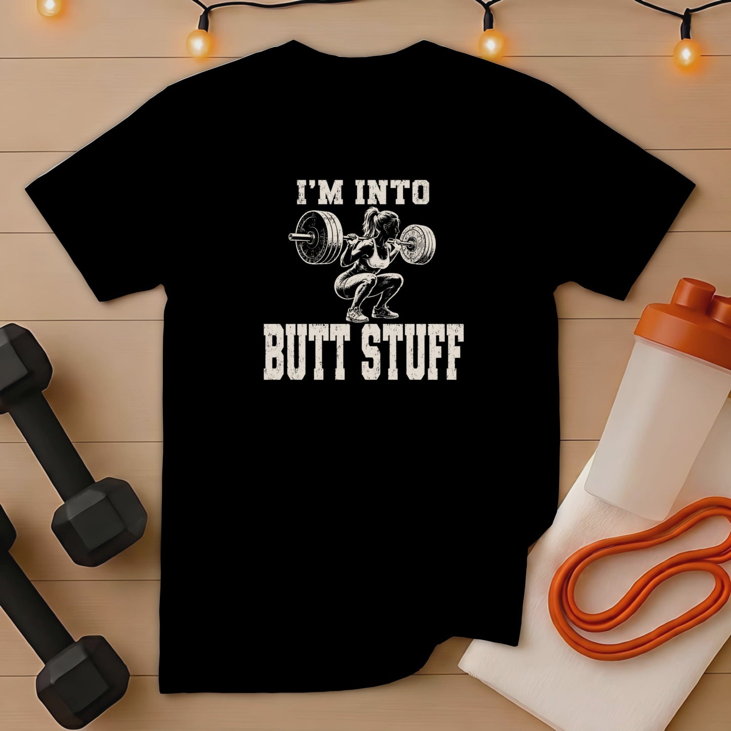 Black t-shirt with "I'M INTO BUTT STUFF" and woman lifting weights.