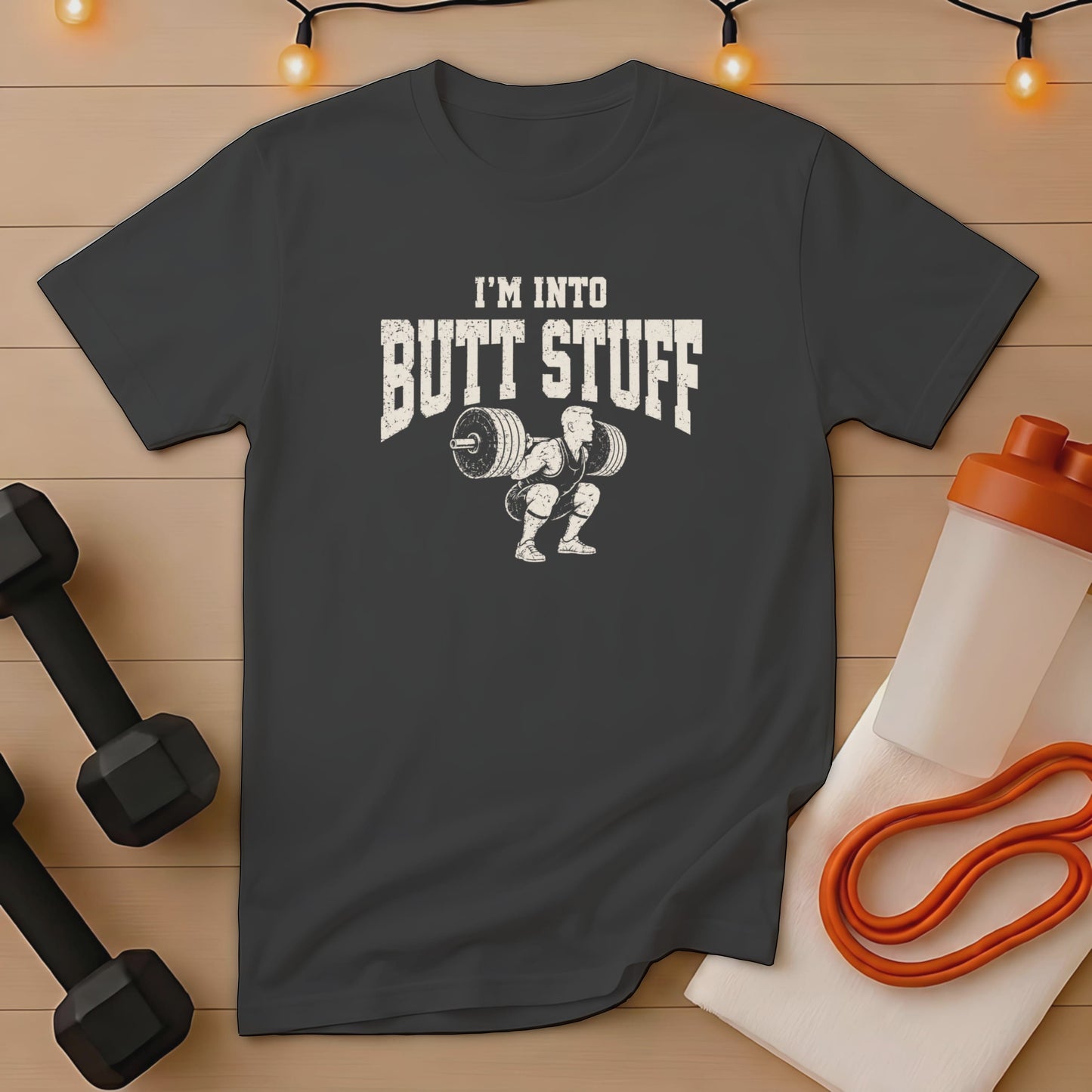 Dark gray t-shirt with "I'm Into Butt Stuff" text and a weightlifter graphic.