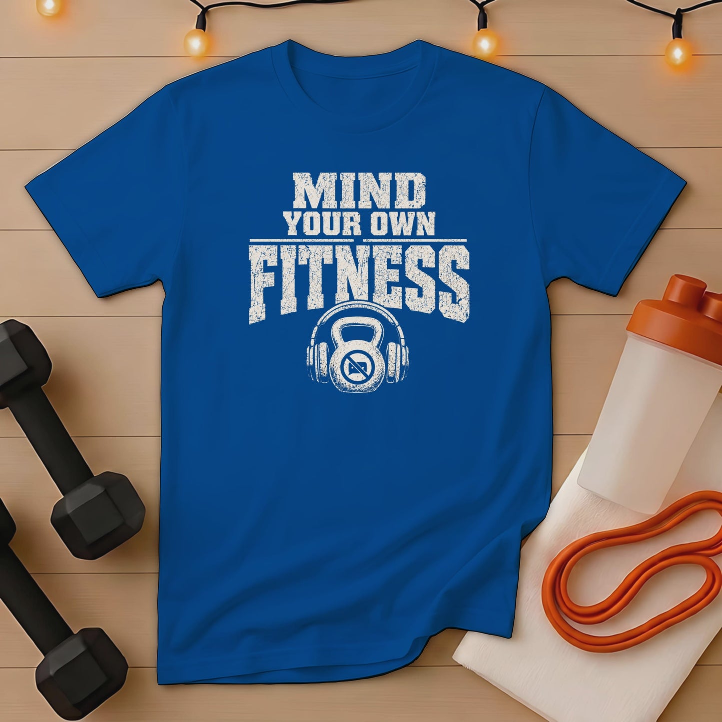 Royal blue t-shirt with "MIND YOUR OWN FITNESS" text and kettlebell graphic.