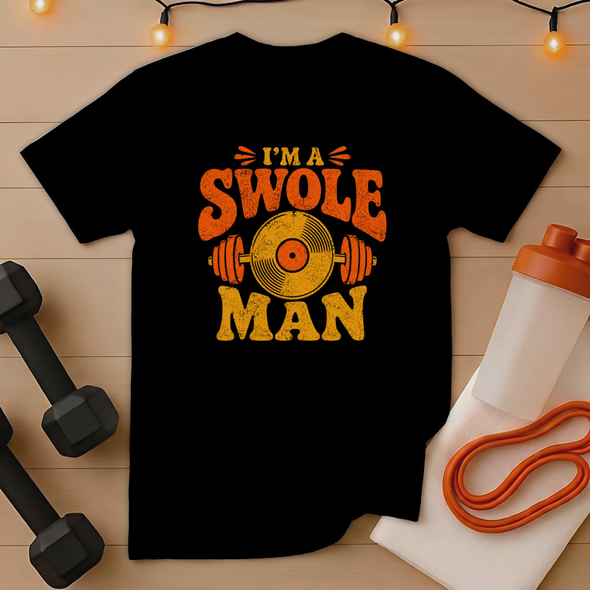 Black t-shirt with distressed orange and yellow text "I'M A SWOLE MAN" and barbell graphic.