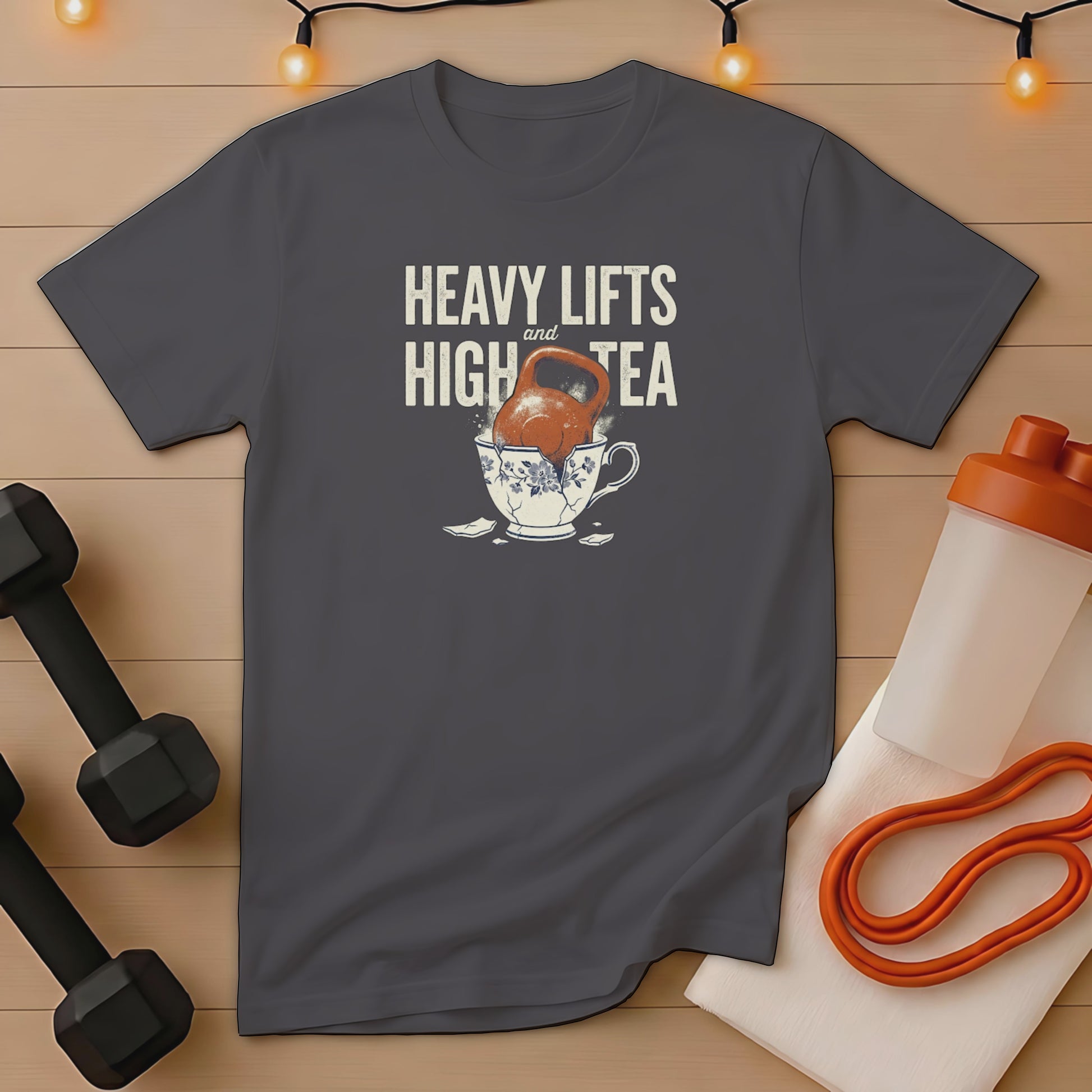 T-shirt with "Heavy Lifts and High Tea" text over a cracked teacup.