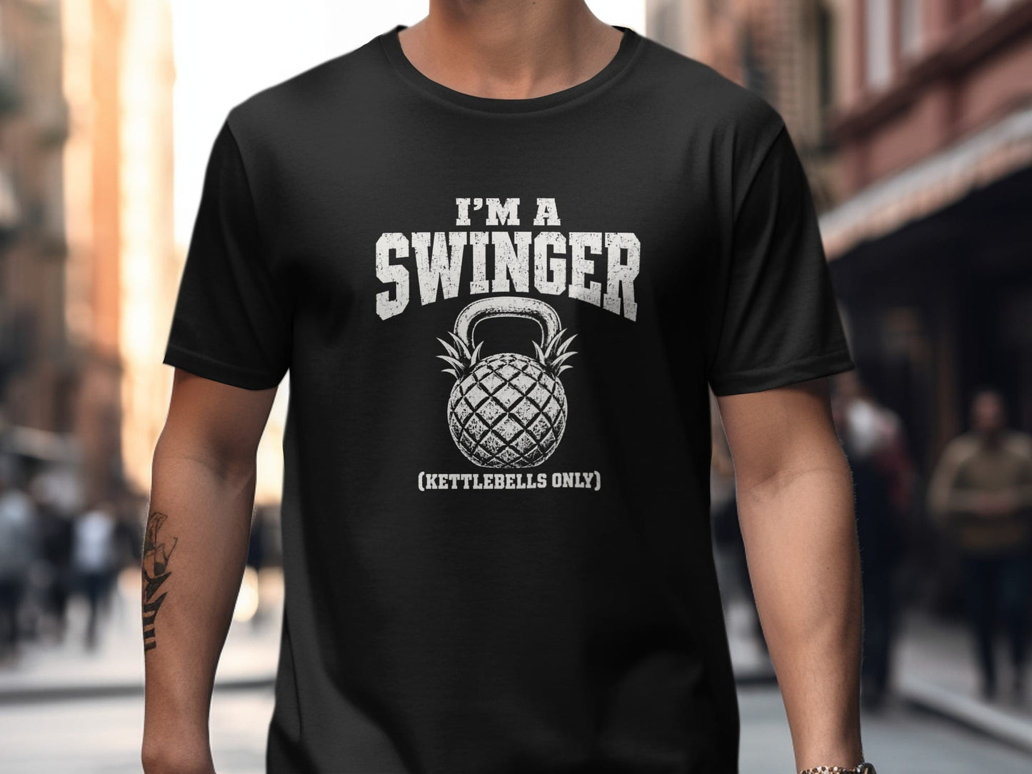 Black t-shirt with distressed text "I'M A SWINGER" and a pineapple kettlebell.
