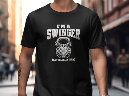 Black t-shirt with distressed text "I'M A SWINGER" and a pineapple kettlebell.