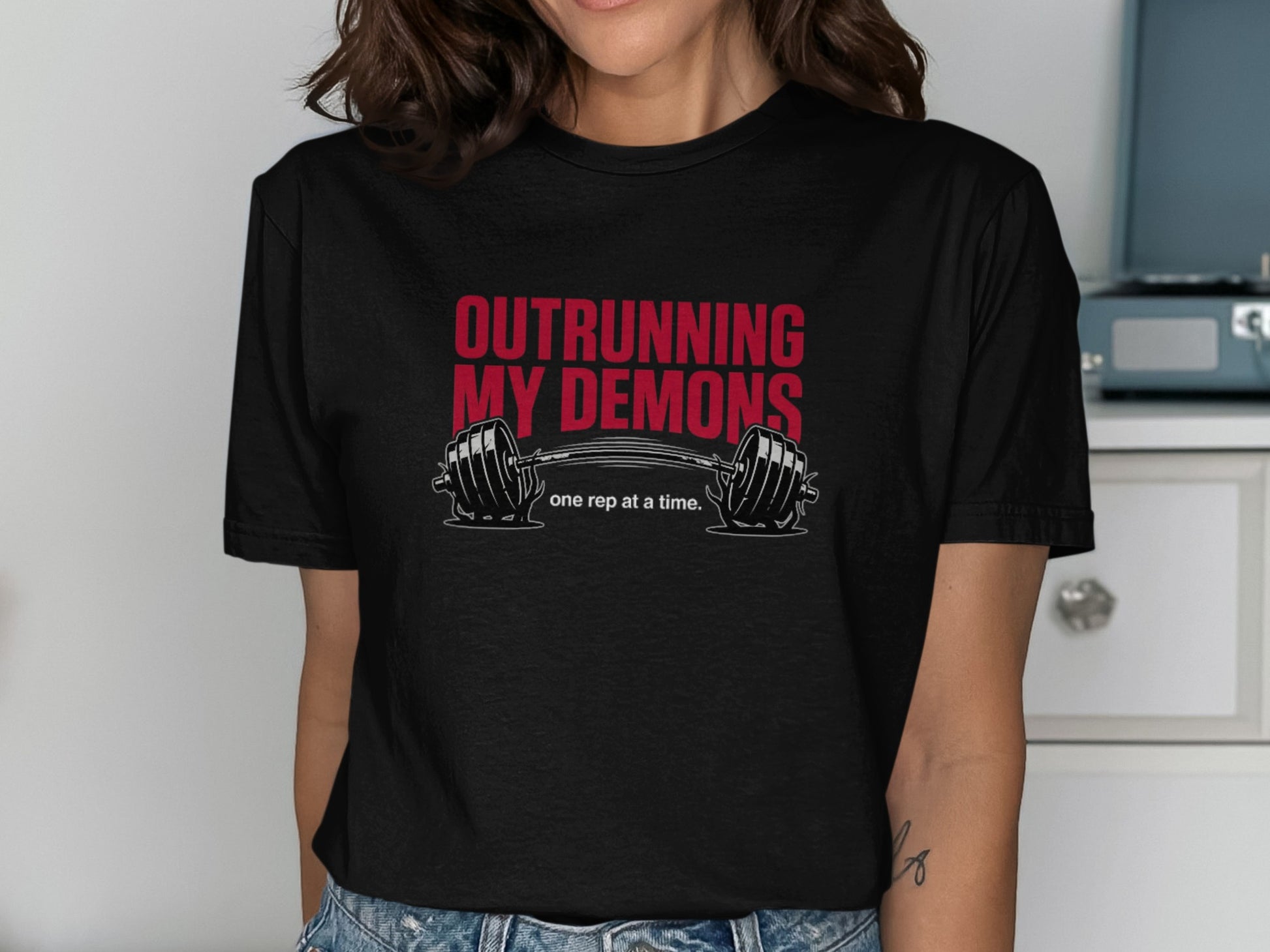 Black t-shirt with "OUTRURNING MY DEMONS" and a barbell.