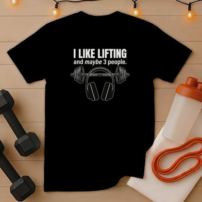 Black t-shirt with headphones graphic and "I like lifting and maybe 3 people" text.