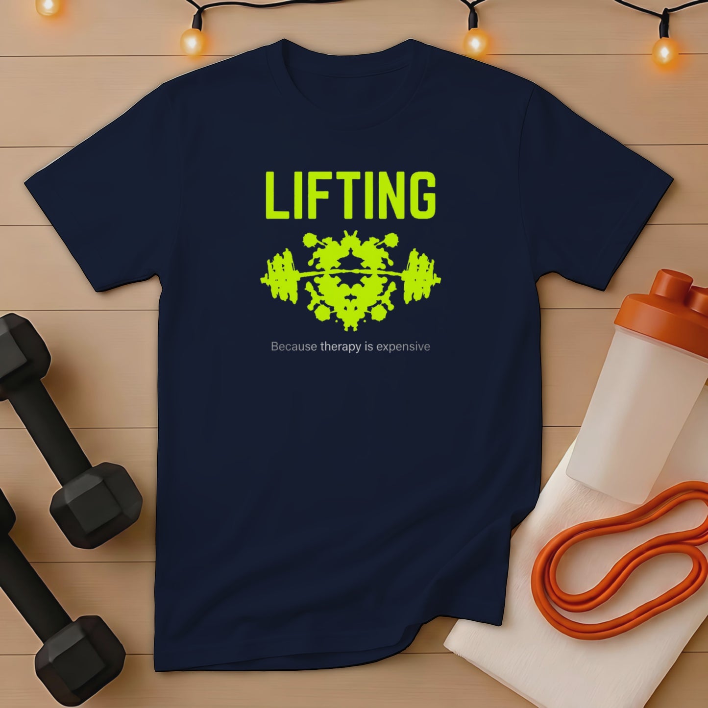 Navy t-shirt with "LIFTING" and a barbell silhouette, next to dumbbells and workout gear.