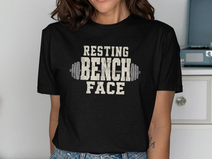 Black t-shirt with distressed "RESTING BENCH FACE" text and barbell graphic.