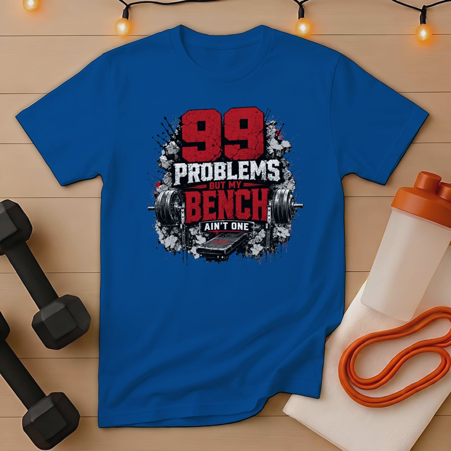 Blue t-shirt with text "99 PROBLEMS BUT MY BENCH AIN'T ONE".