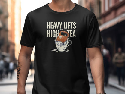 Black t-shirt with text "Heavy Lifts and High Tea" above a kettle in a teacup.