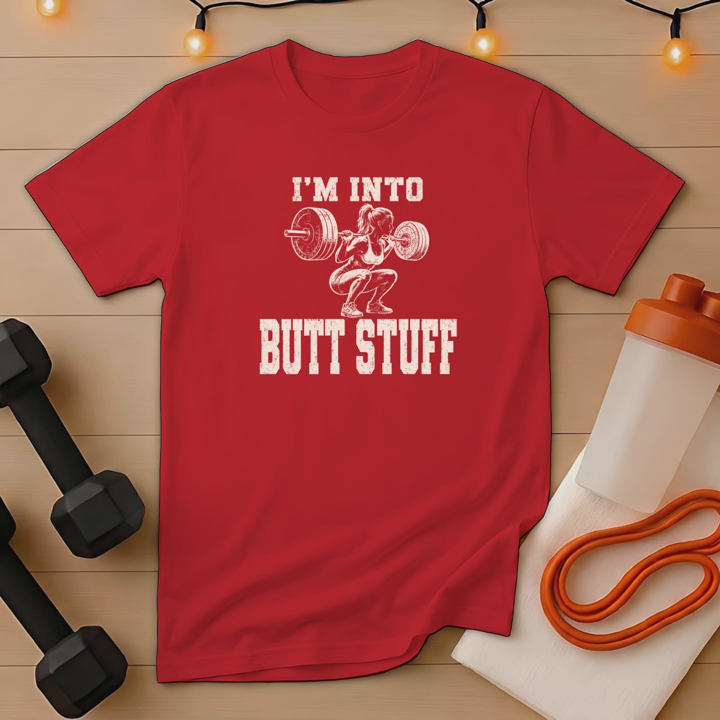 Red t-shirt with "I'M INTO BUTT STUFF" text and squatting woman graphic.