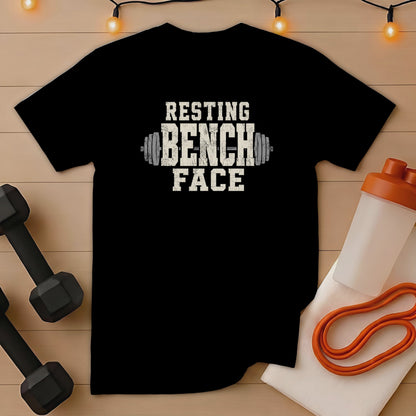 Black t-shirt with "RESTING BENCH FACE" text and dumbbell graphics.