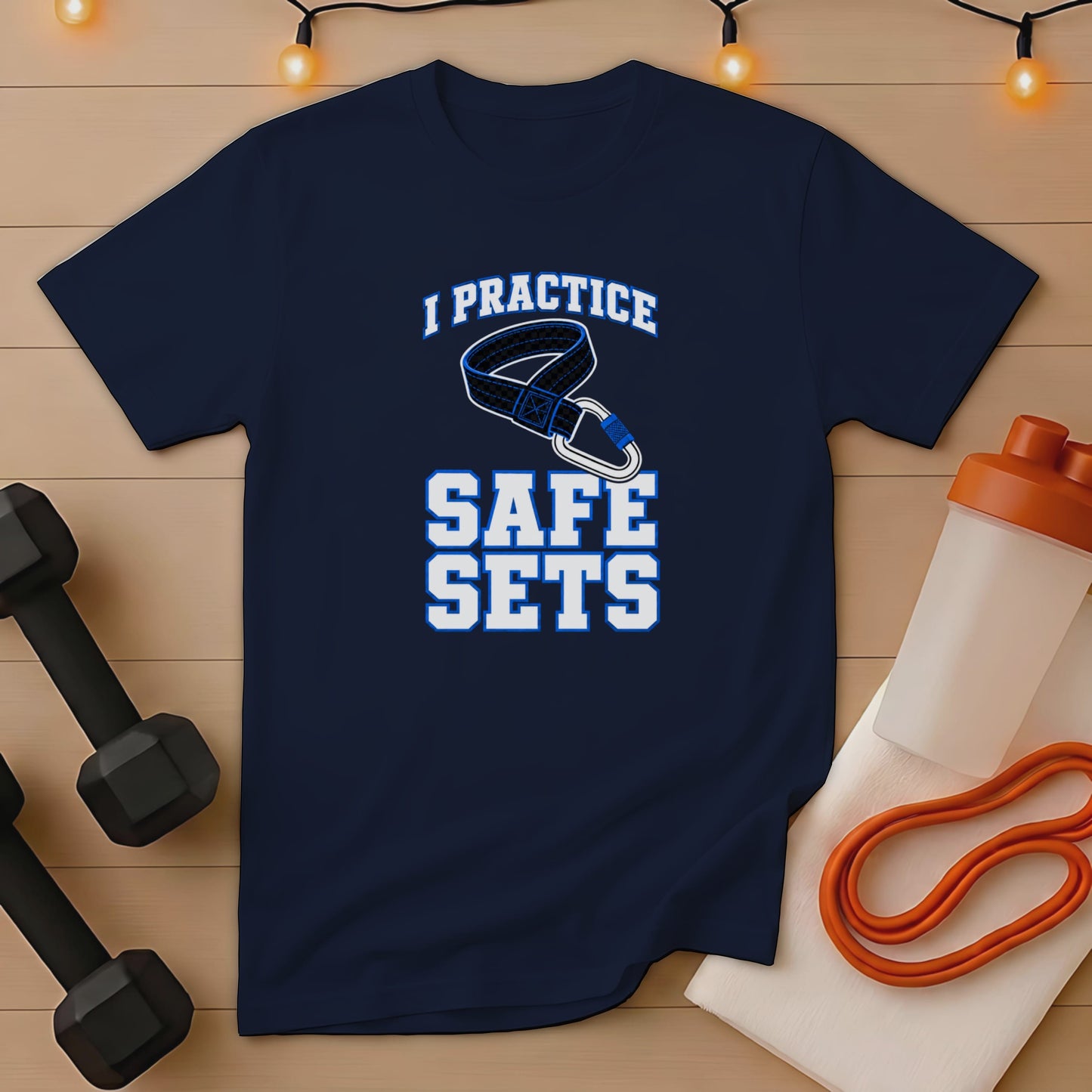 Navy t-shirt with "I PRACTICE SAFE SETS" graphic and workout accessories.