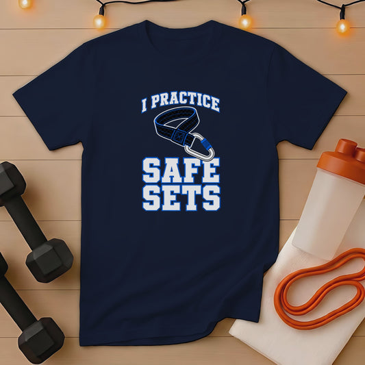 Navy t-shirt with "I PRACTICE SAFE SETS" graphic and workout accessories.