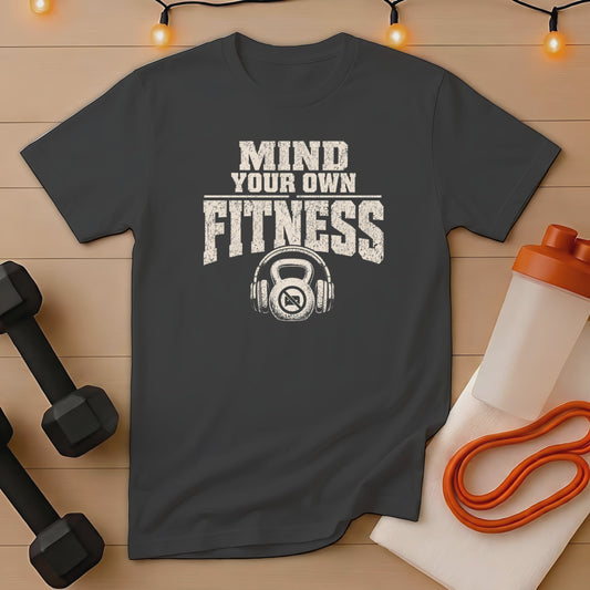 Dark t-shirt with "MIND YOUR OWN FITNESS" and kettlebell with headphones graphic.