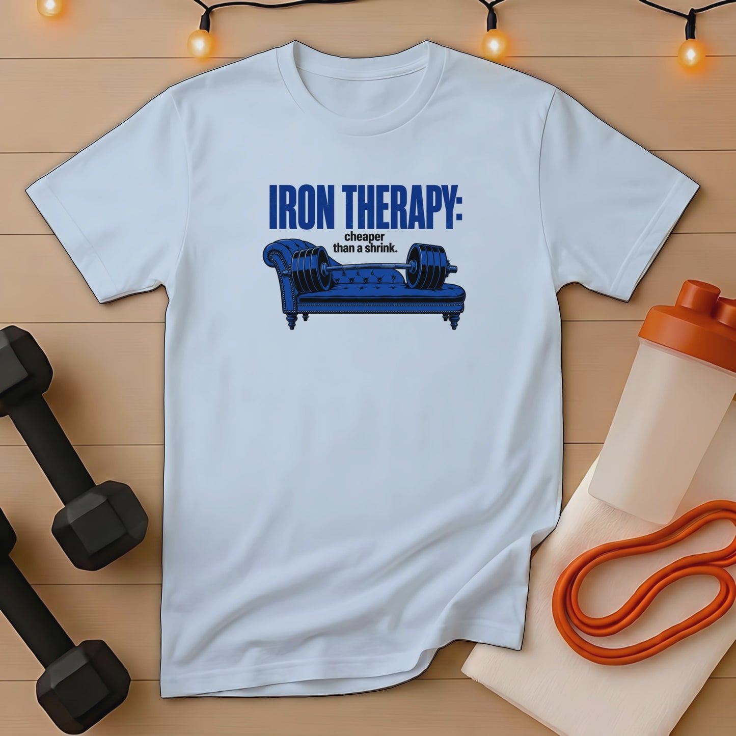 White t-shirt with "Iron Therapy: cheaper than a shrink" text and a dumbbell sofa graphic.