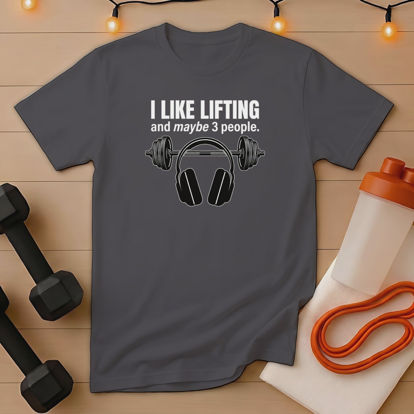 Dark grey t-shirt with white text "I LIKE LIFTING and maybe 3 PEOPLE." and headphones graphic.