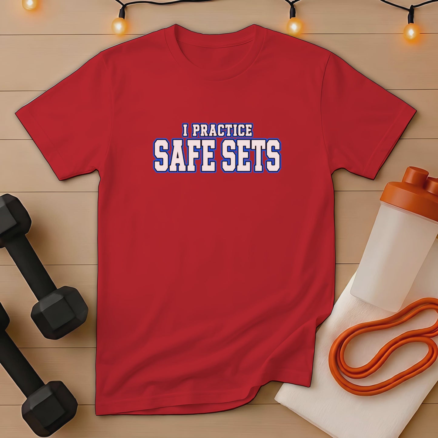 Red t-shirt with "I PRACTICE SAFE SETS" text, dumbbells, and shaker bottle.