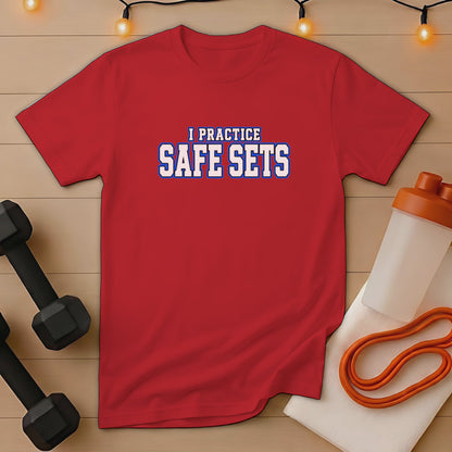 Red t-shirt with "I PRACTICE SAFE SETS" text, dumbbells, and shaker bottle.