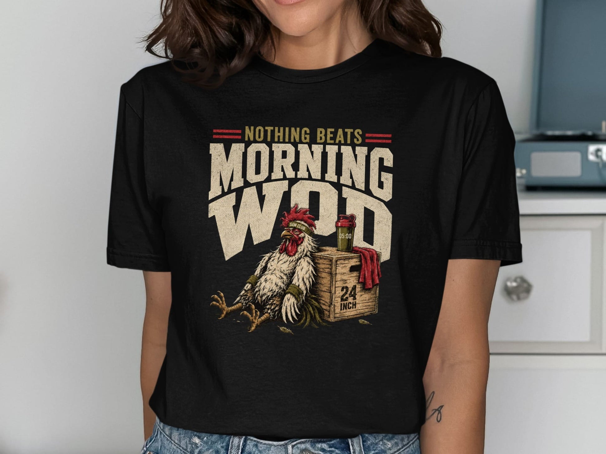 T-shirt with "Nothing Beats Morning WOD" text and a tired rooster sitting on a box.