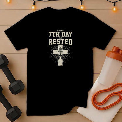 Black t-shirt with "on the 7th day he rested" text and praying hands.