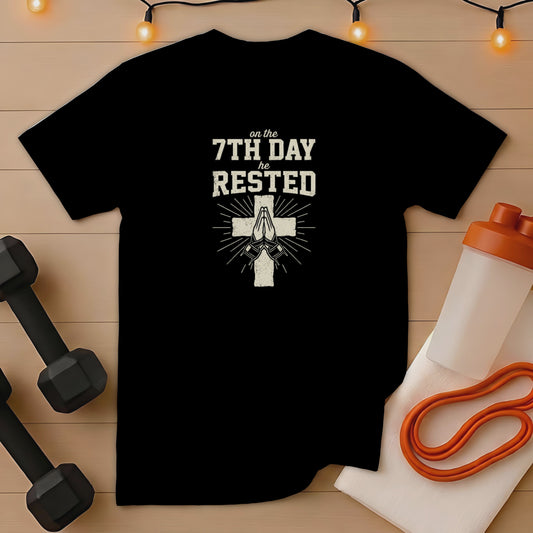 Black t-shirt with "on the 7th day he rested" text and praying hands.