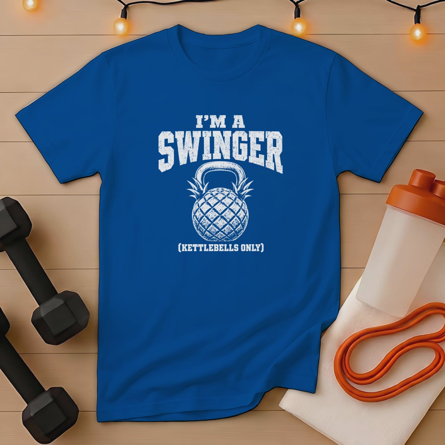 Blue t-shirt with "I'm a Swinger (Kettlebells Only)" and pineapple kettlebell graphic.