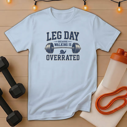 Light blue t-shirt with "Leg Day Because Walking is Overrated" barbell and snail graphic.