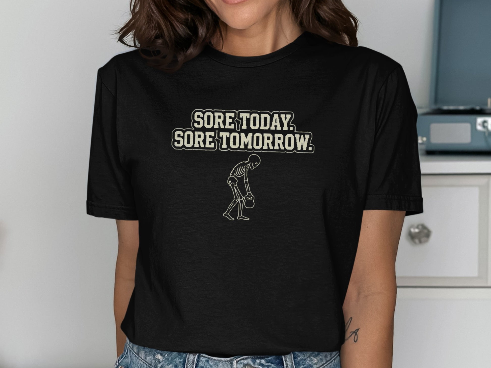 Black t-shirt with "SORE TODAY, SORE TOMORROW" and skeleton graphic.