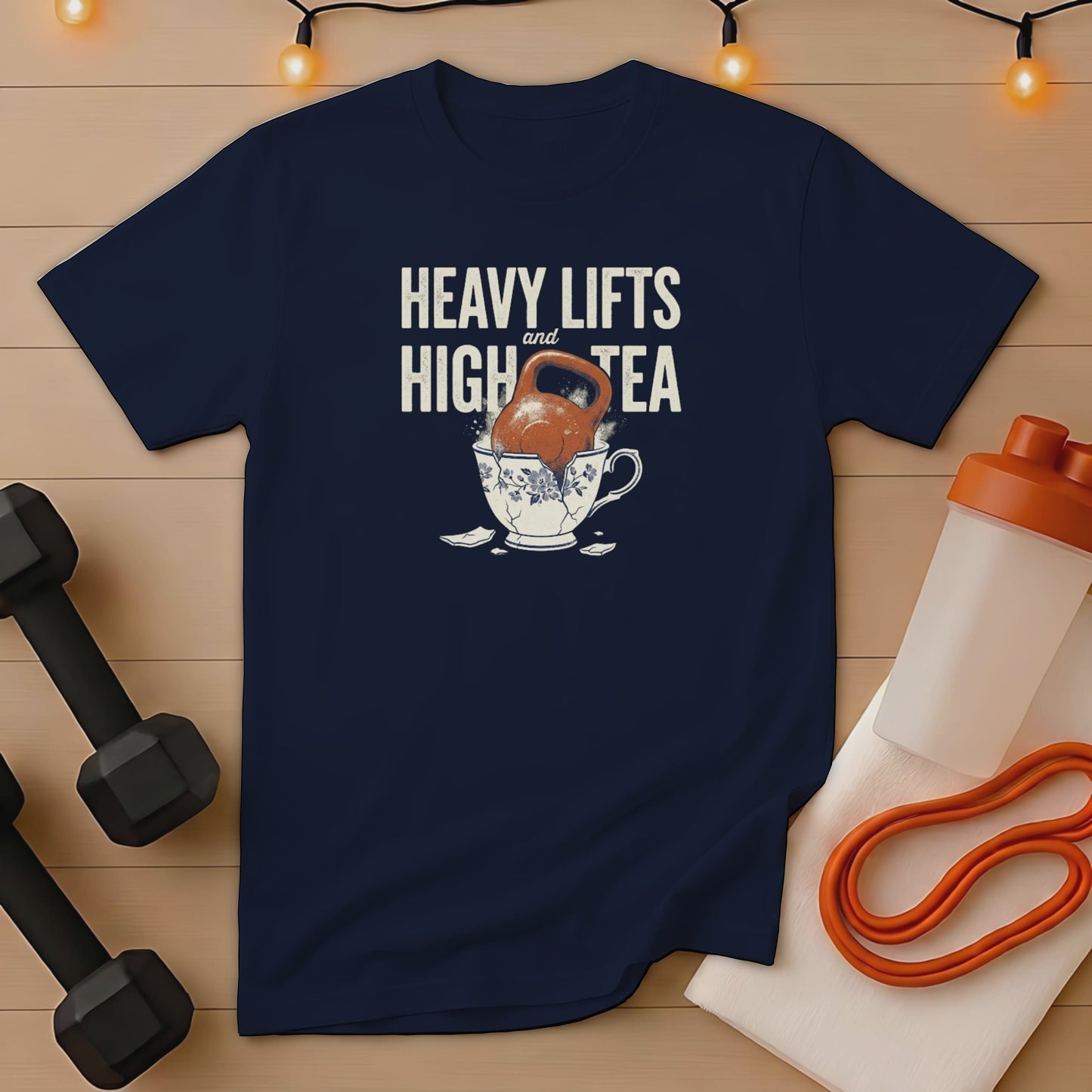 Navy t-shirt with "Heavy Lifts and High Tea" text and kettlebell in a teacup.