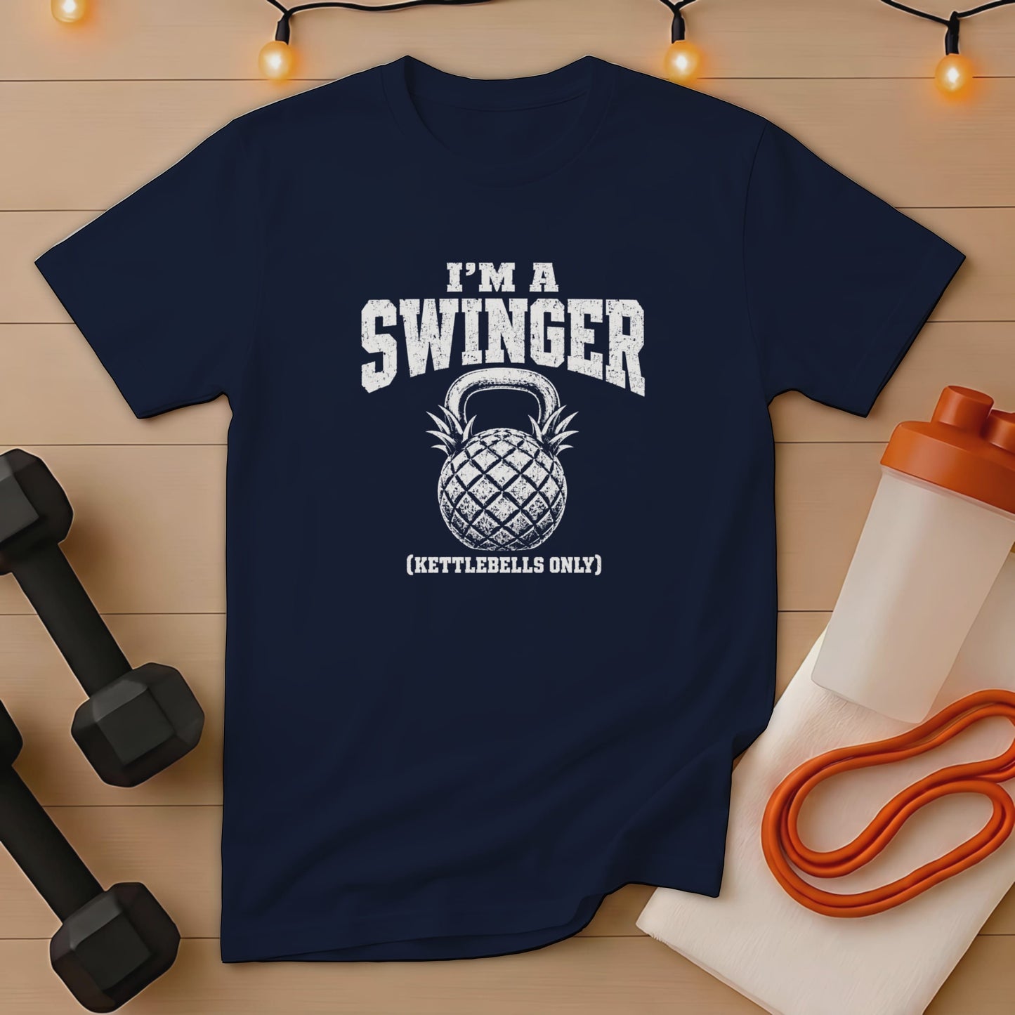 Navy t-shirt with "I'm a Swinger (Kettlebells Only)" text and pineapple kettlebell graphic.