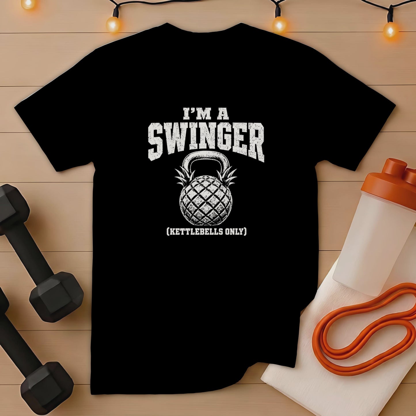 Black t-shirt with "I'm a Swinger (Kettlebells Only)" graphic and kettlebell pineapple.