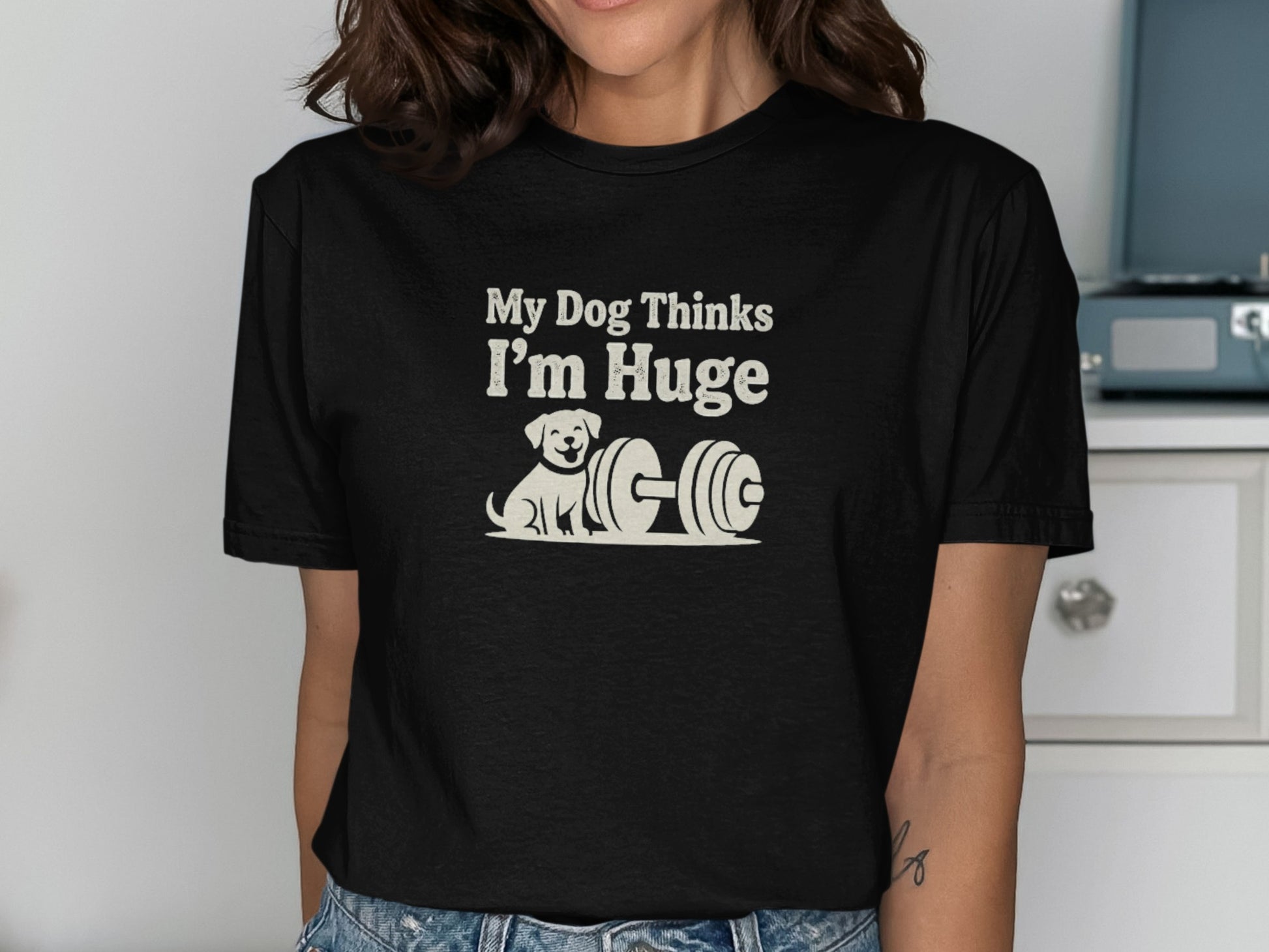 Black t-shirt with "My Dog Thinks I'm Huge" and a cartoon dog next to a dumbbell.