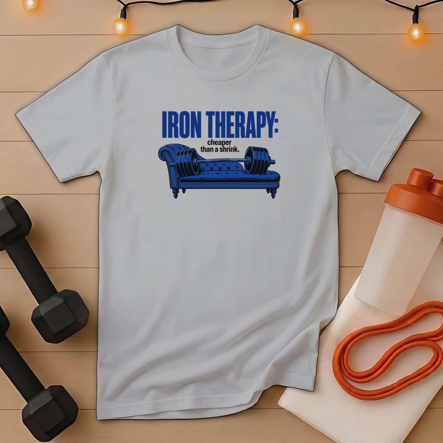 Gray t-shirt with "Iron Therapy: cheaper than a shrink" text and a dumbbell on a couch graphic.