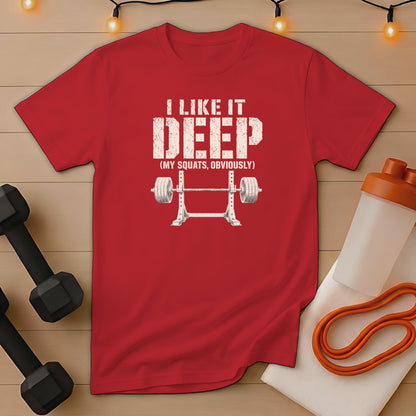 Red t-shirt with distressed graphic "I LIKE IT DEEP (MY SQUATS, OBVIOUSLY)" and barbell.