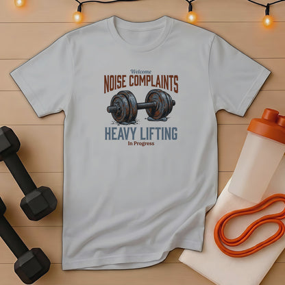 T-shirt with "NOISE COMPLAINTS HEAVY LIFTING In Progress" text and dumbbell graphic.