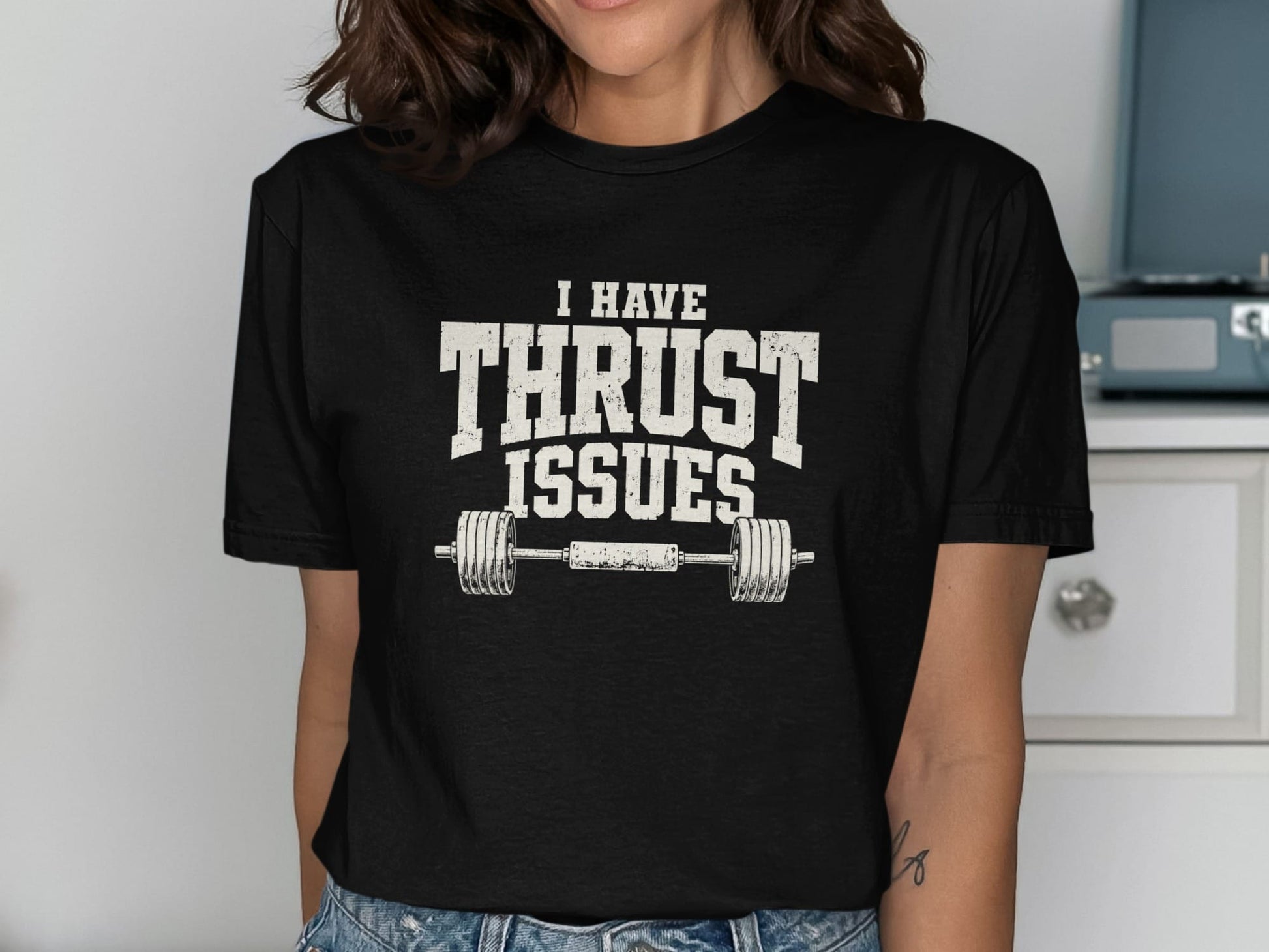 Black t-shirt with white distressed text "I HAVE THRUST ISSUES" and a barbell graphic.