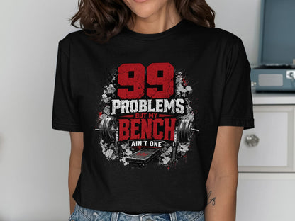 Black t-shirt with "99 Problems But My Bench Ain't One" and weightlifting graphics.