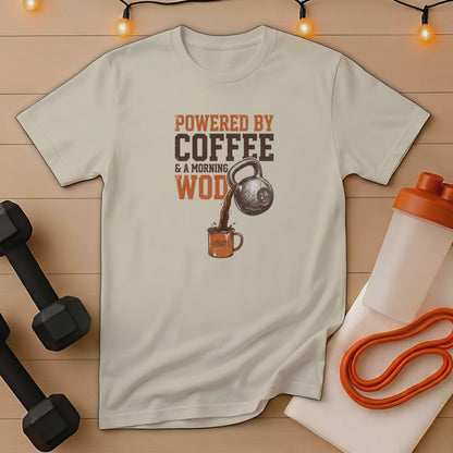 T-shirt with text "POWERED BY COFFEE & A MORNING WOD" and kettlebell pouring coffee.